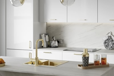 Close-up view of brass details in Nova Gloss White smooth slab surface kitchen.