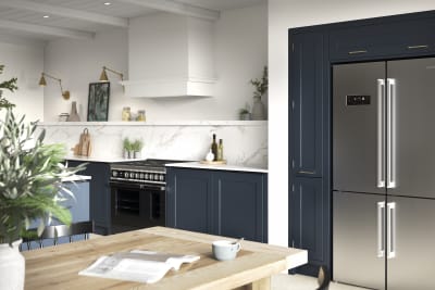 Open plan Shaker style kitchen in shade Midnight, with integrated handles, and an American fridge-freezer.