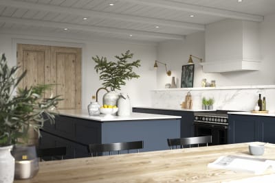 View of kitchen from dining room table, a modern and traditional kitchen decorated with green plats.