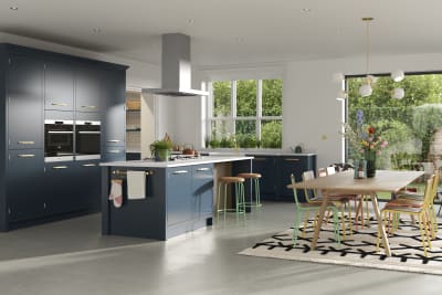 Full room view of Soho Voyage Blue kitchen with contemporary dining room table and chairs in bright colours.