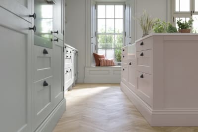 Ludlow, a traditional Shaker-style kitchen range featuring panelled doors with visible woodgrain and beading detail, in the light airy shade Seagrass.