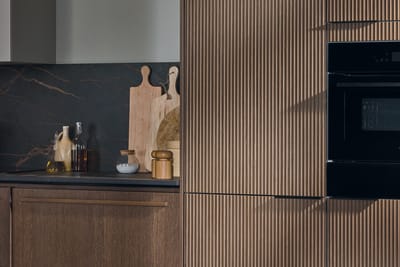 Magnet's kitchen Nordic Nature, with tall cabinet in wave fronts.