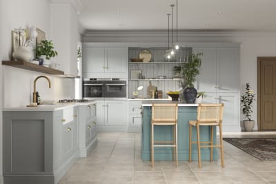 Traditional Shaker-style kitchen range in light grey with a blue kitchen island.