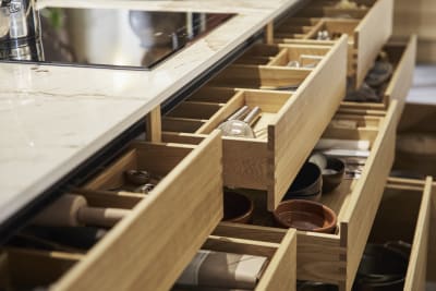 Full view of oak inserts in opened oak drawers in the Nordic Craft kitchen island.