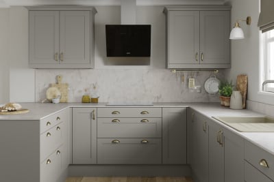 U-shape Tatton kitchen from Magnet in the shade Pebble, brass handles and accessories and a light marbled worktop with matching splashback.