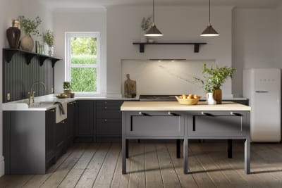 A dark grey Shaker kitchen with Charcoals cabinetry, with a kitchen island covered with a wooden worktop.