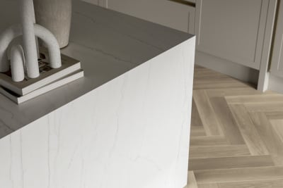 Close-up of Kitchen island with marble worktop and decorative side panel.