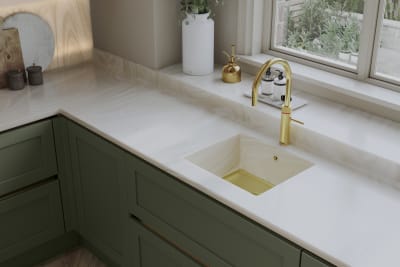 Overhead view of Integra Wardley in shade Misty Moors, with a white worktop and sink, paired with a brss kitchen tap.