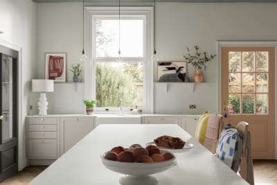 View of kitchen island in traditional shaker kitchen Wardley with modern shades and decorations.