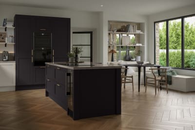 The Ambleside kitchen in a dark Graphite shade, in a contemporary kitchen setting with wooden herringbone flooring.