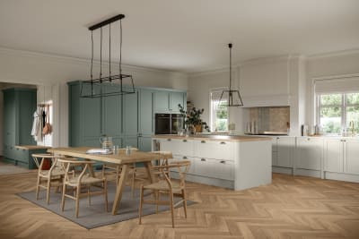 Ambleside Shaker kitchen in Moss and Limestone colours, featuring cup handles, and a spacious open-plan layout.