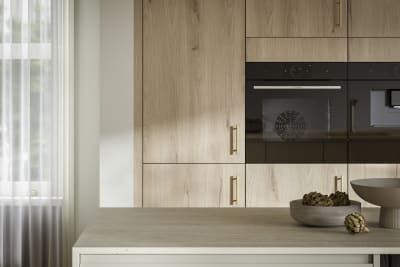 A bright and airy open-plan kitchen that incorporates Duxbury drawers and cabinets in Limestone, and Portobello units in Bosco.