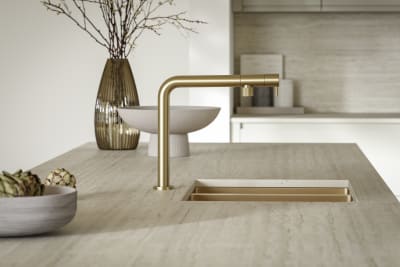 Minimalist kitchen island worktop with brass sink and tap