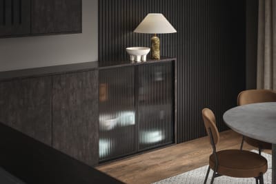 Elegant fluted glass cabinets are offset against the organic woodgrain texture of Magnet's Portobello kitchen range in dark Etna.