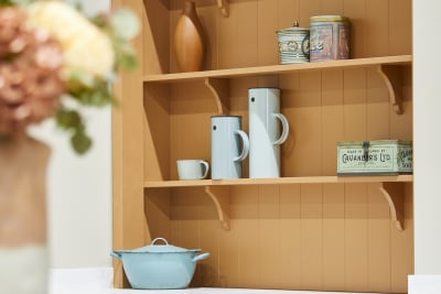 Close-up of orange open shelves with matching frame and wall paneling in Nutmeg shade in the shaker kitchen Wardley