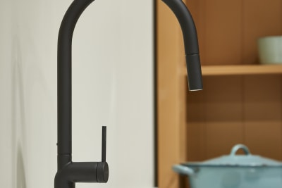 Close-up of matt black tap in shaker kitchen