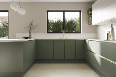 Painted handleless slab front Integra Soho from Magnet in shade Thyme paired with wall cabinets in shade Limestone, finished with brass details and plants.