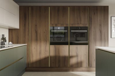 Integra Portobello tall cabinetry with integrated ovens, paired with painted handleless slab front Integra Soho in Shades Thyme and Limestone, from Magnet.