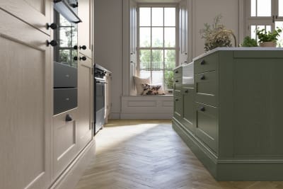 Traditional Shaker-style kitchen range Ludlow with tactile woodgrain in neutral shade Shell with a green Thyme kitchen island.