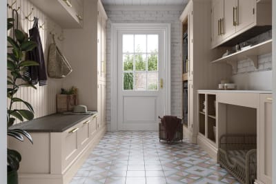 Combined Utility room and entrance hallway, with Wardley shell cabinetry on each side, paired with brass handles and organic materials in laundry baskets, dog bed and a large potted plant.