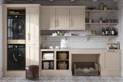 Utility room Wardley Shell cabinetry with washing machine and dryer built-in, a countertop and wall cabinets all matching, a laundry basket on the floor next to washing machine.