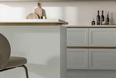 Integra Dunham Washed Cotton, a handleless shaker frontal with brass details and a white worktop..