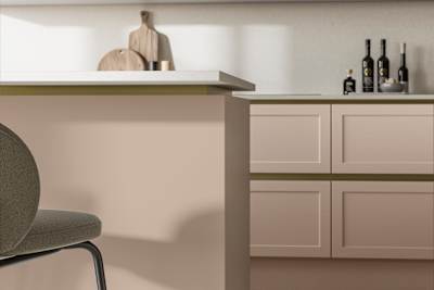 Integra Dunham Chalk Blush, a handleless shaker frontal with brass details and a white worktop..