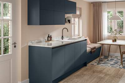 Handleless Integra Ascoli Mineral Blue, a dark blue kitchen with a rounded matt black tap with white sink, a white and grey marbled worktop with matching upstand.