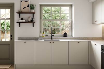 Modern slab kitchen Ascoli in neutral shade Limestone with brass knobs and black tap