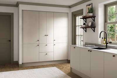 Modern slab kitchen Ascoli in neutral shade Limestone with brass knobs and black tap