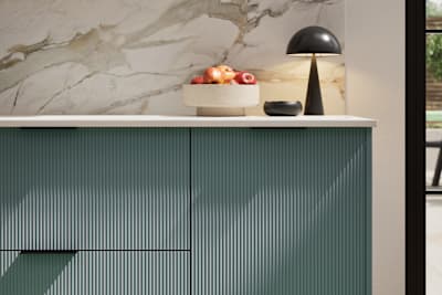 Fluted front kitchen Reed from Magnet in blue shade Morris Blue, with a marbled splashback and black handles, herringbone wood flooring.
