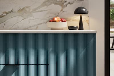 Fluted front kitchen Reed from Magnet in rich blue shade Carrington Blue, with a marbled splashback and black handles, herringbone wood flooring.