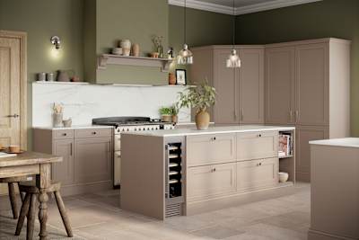 Shaker style painted wood grain Bewdley kitchen in neutral shade Cornish Clay, tall cabinets and kitchen island with marbled worktop and matching backsplash, wine cooler in the kitchen island and gas range cooker.