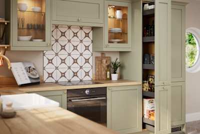 Opened pull-out larder in contemporary Shaker kitchen Ambleside from Magnet in sage green shade Meadow with belfast sink, aged taps and wooden effect worktop.