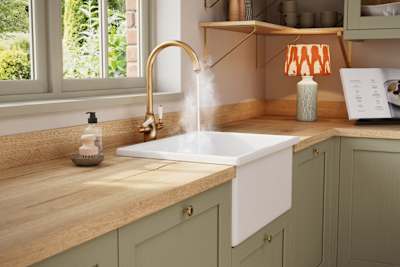 Contemporary Shaker kitchen Ambleside from Magnet in sage green shade Meadow with belfast sink and traditional style tap with hot water.