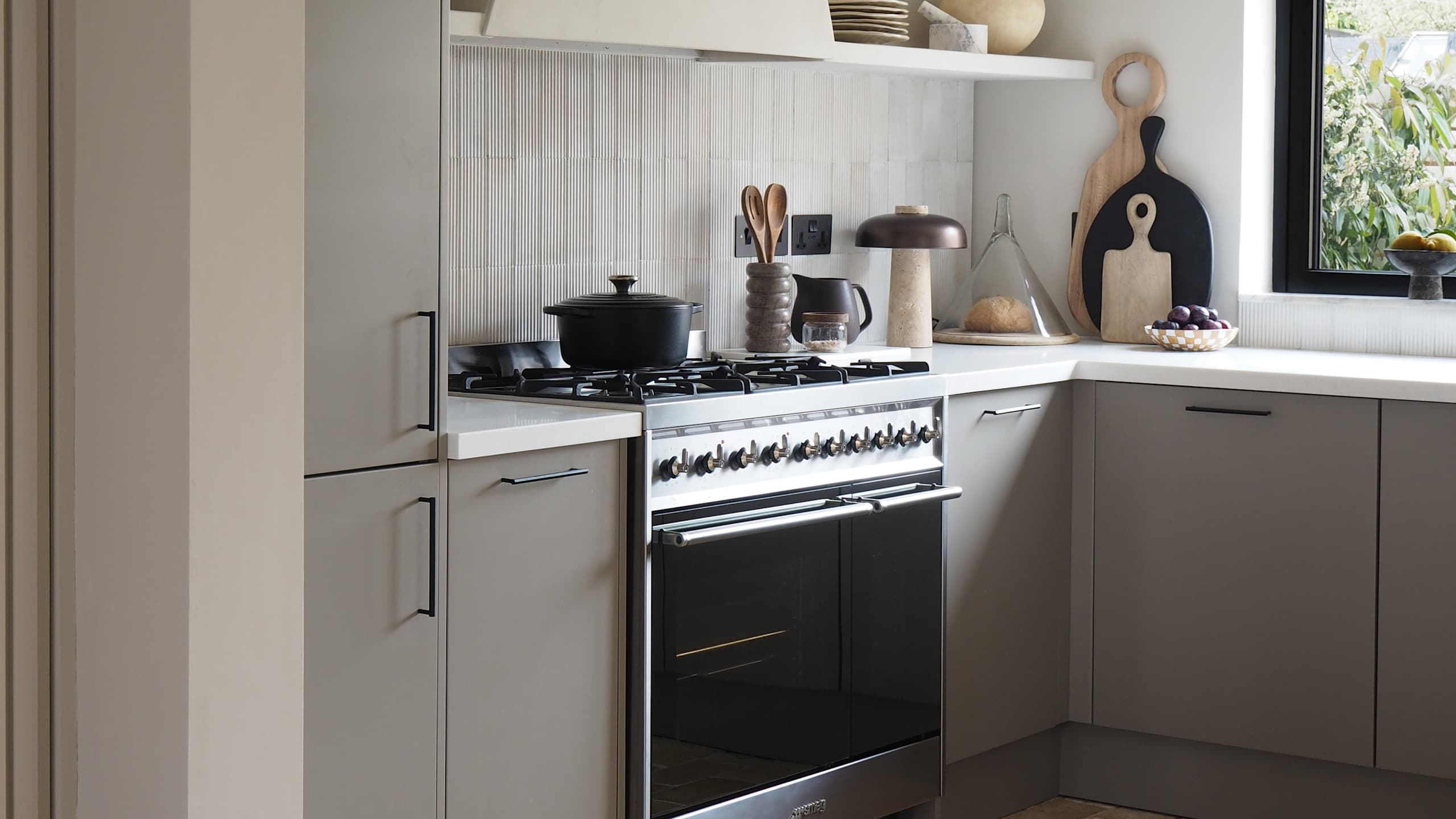 Grey kitchen in neutral earthy tones from Magnet with a range cooker and slab fronts