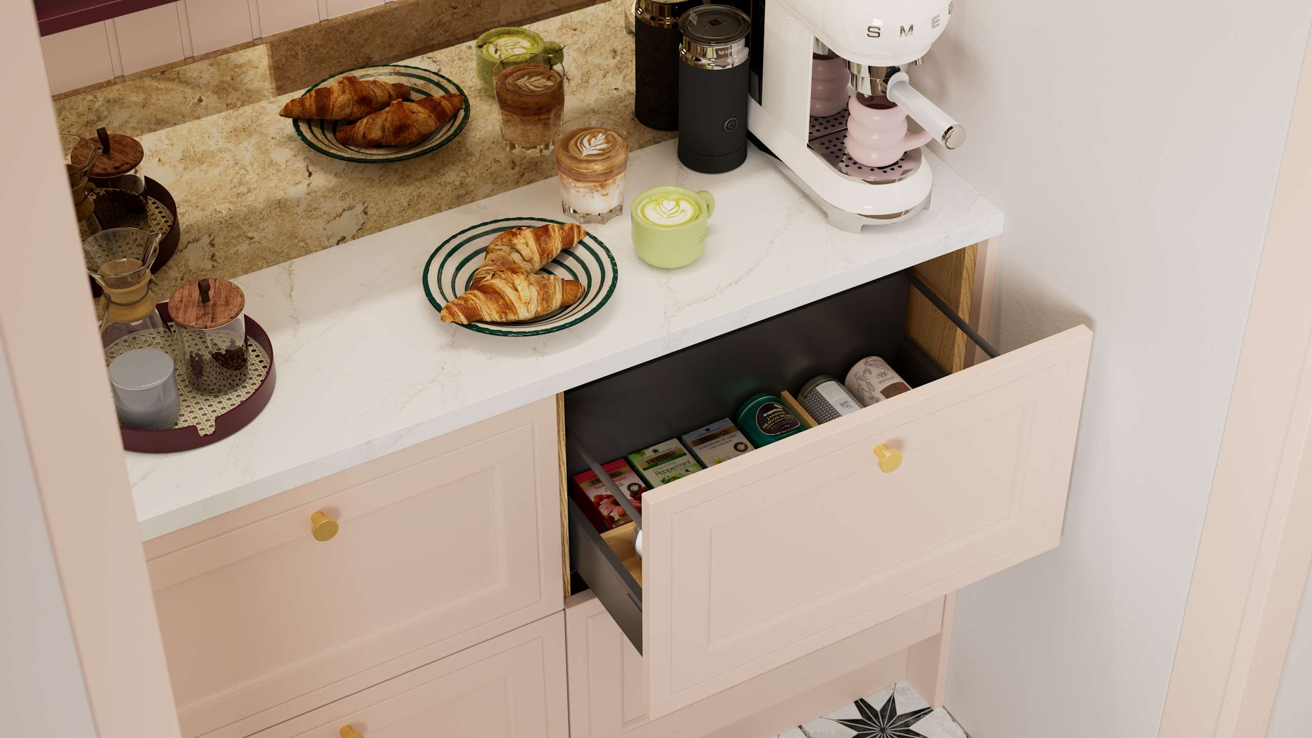 Opened drawer of teas in painted wood grain Shaker style Bewdley cabinets in light pink shade Chalk Blush, with marbled worktop, brass knobs and Smeg coffee machine on countertop.