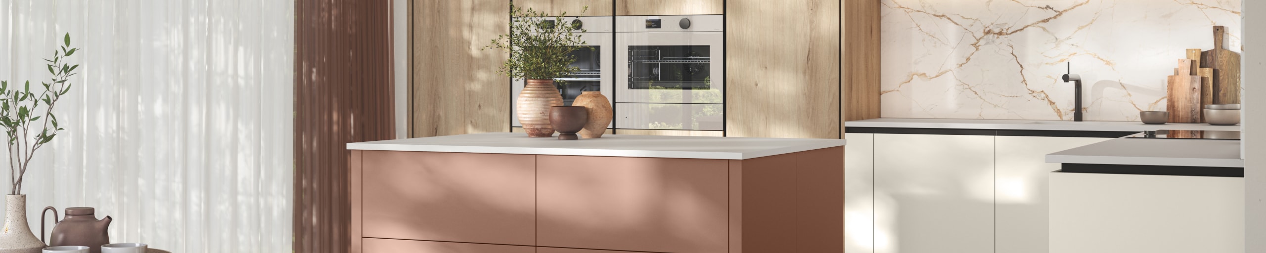 Modern frameless slab door with integrated handles, white cabinets paired with tall light wood Integra Portobello organic woodgrain cabinets and a kitchen island in the shade Baked Clay, Integra Soho from Magnet.