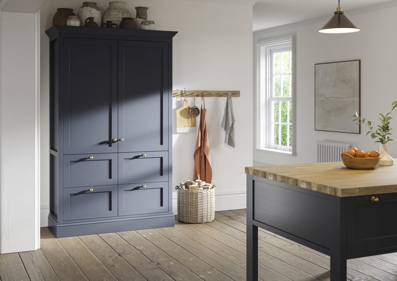 Tall shaker cabinet in dark blue shade, with handmade ceramics on top.