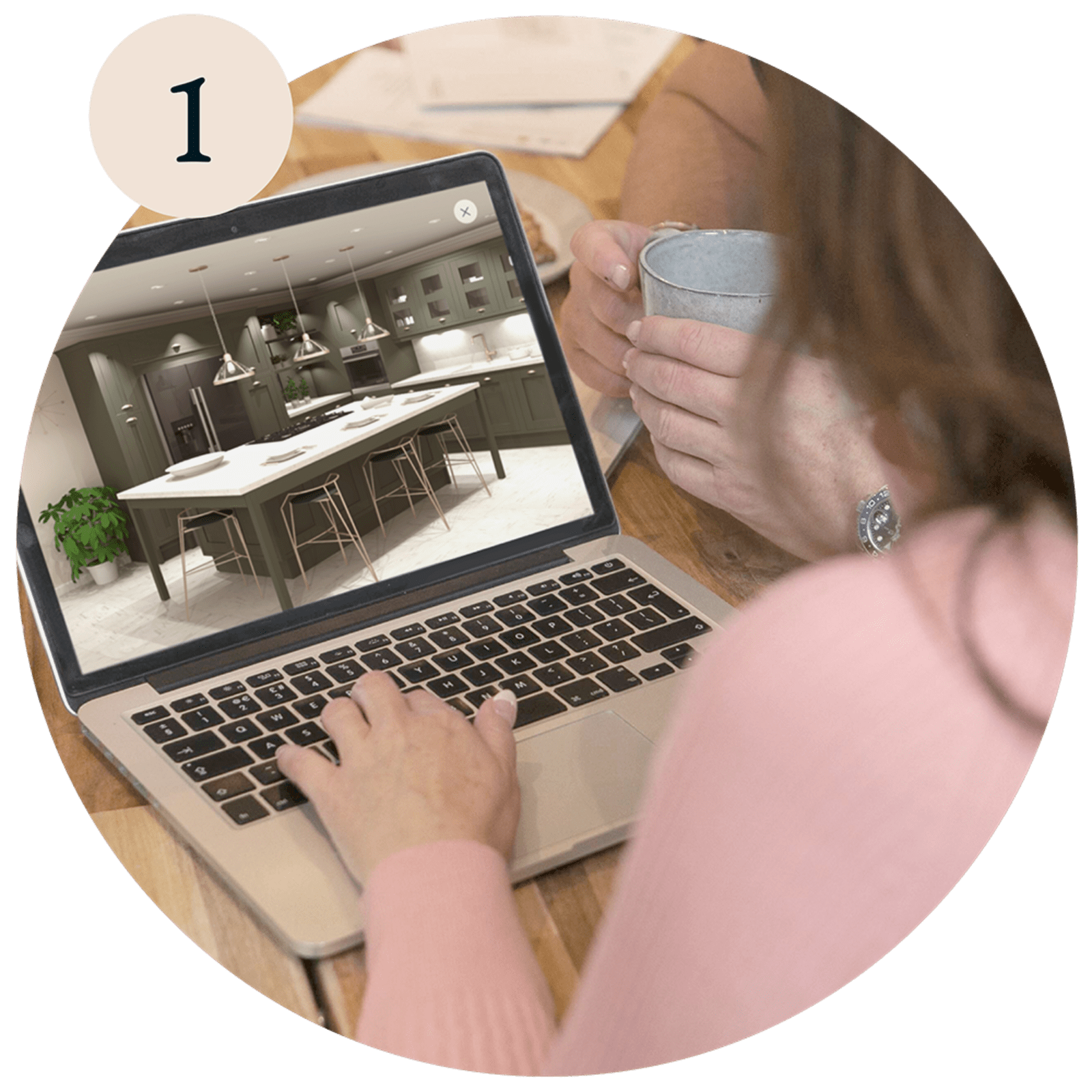 A woman using a laptop, viewing kitchen designs