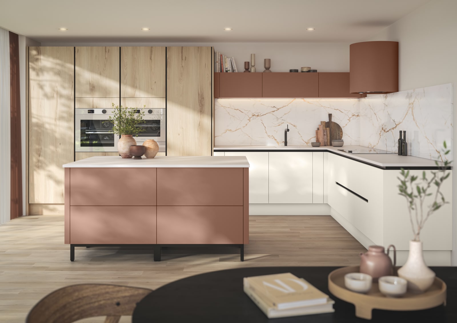 Integra Portobello Bosco as tall cabinets with integrated Samsung Ovens, white handleless Integra Soho cabinetry and a kitchen island in the shade Baked Clay, matching top cabinets and the beautiful fan above hob, all decorated with earth tone ceramics and plants.