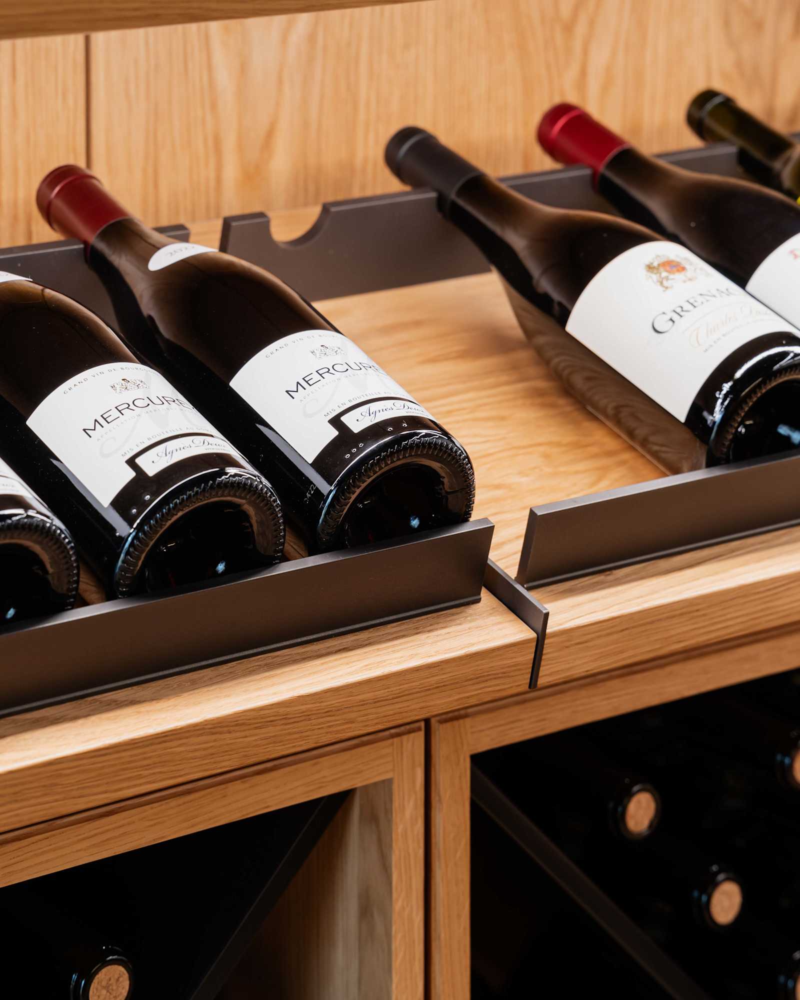 Wine cellar with slanted shelves for bottles on display.
