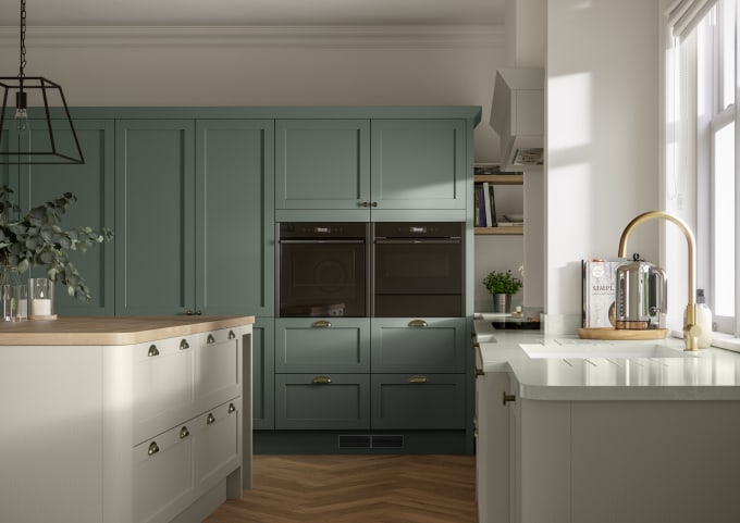 A contemporary kitchen with green and cream cabinets in Ambleside, featuring a Shaker-style design.