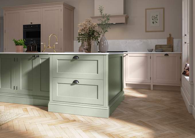 Traditional Shaker-style kitchen range Ludlow with tactile woodgrain in neutral shade Shell with a green Thyme kitchen island.
