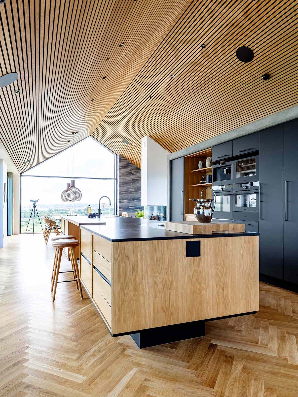 The large kitchen island forms the central focus point in the Scandinavian home