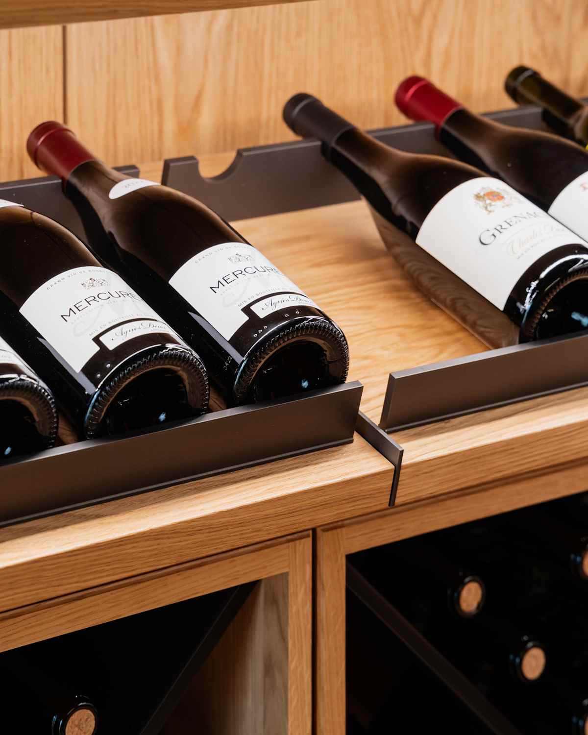 Wine cellar with slanted shelves for bottles on display.