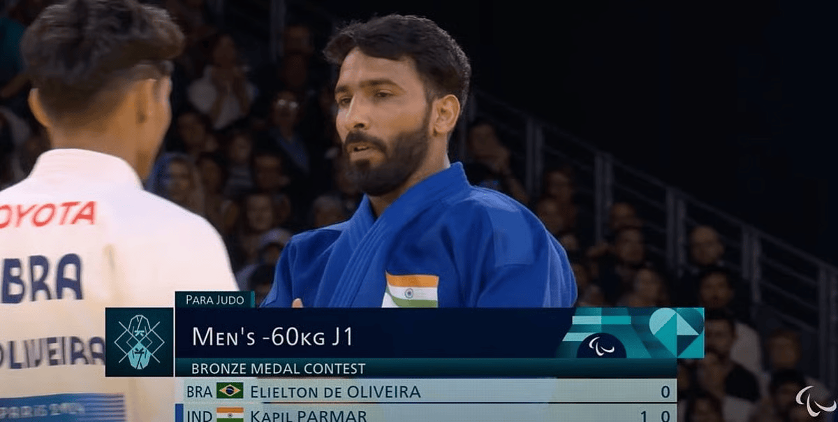 Kapil Parmar in competition, raising his arm after a win – Indian visually-impaired judoka