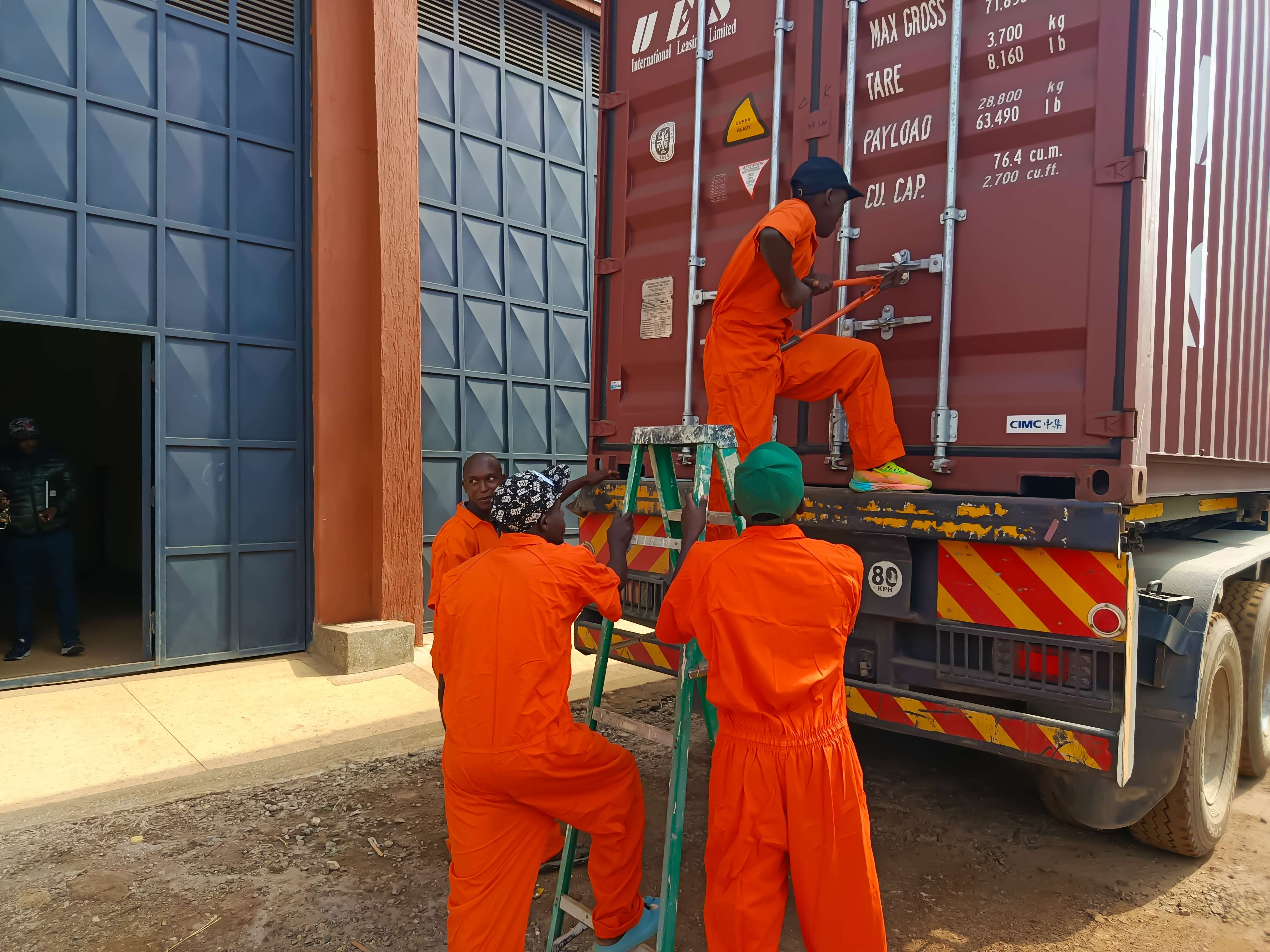 Crew securing a shipping container for sailing