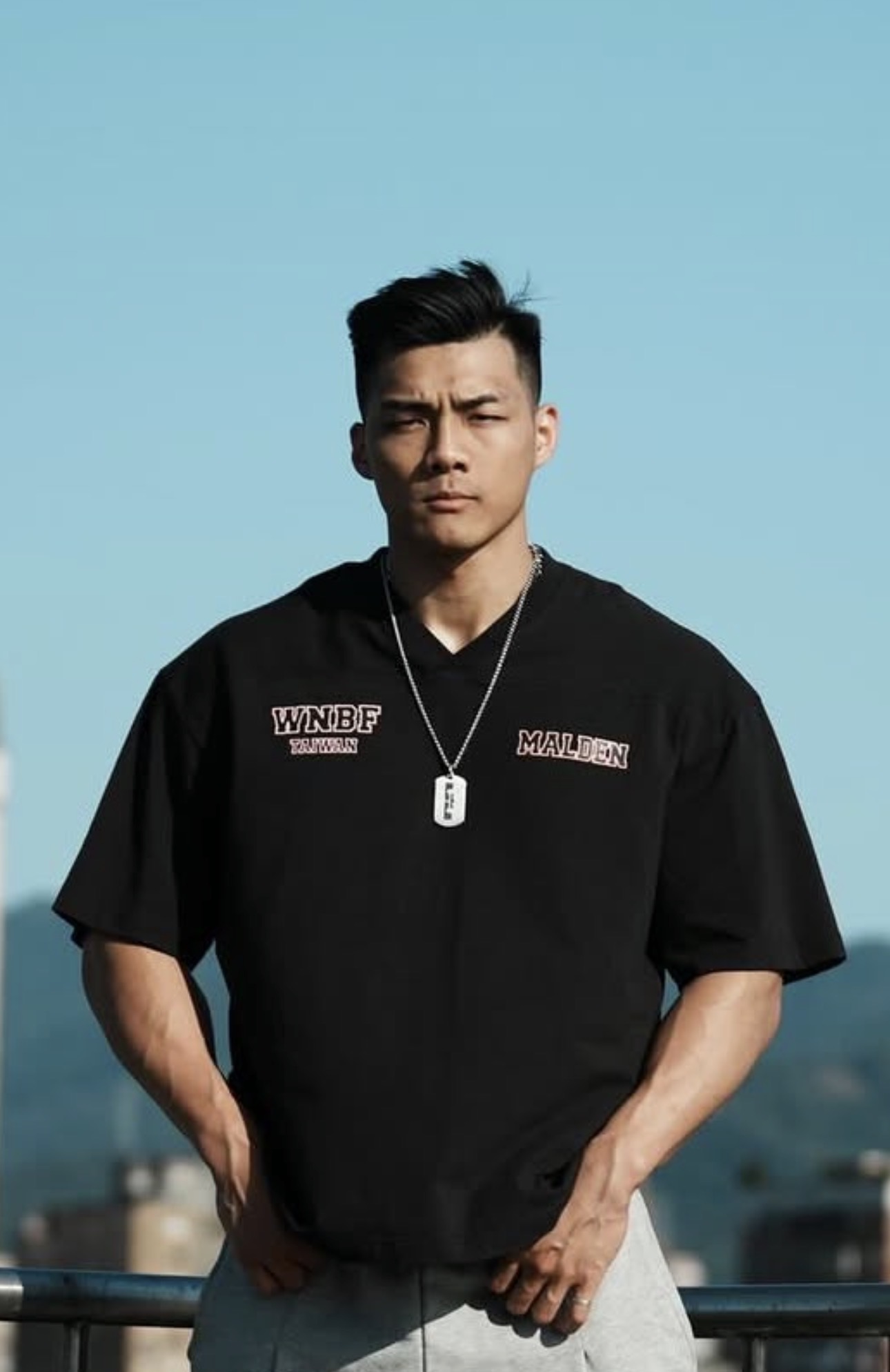 Fitness coach outdoors in athletic wear representing a clean commercial gym look