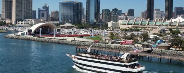 cruise boat on water with skyline — Flagship Cruises & Events, from its own website